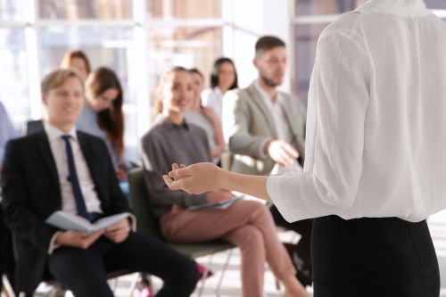 Business trainer giving presentation to group of people